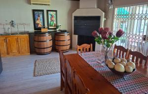 a dining room table with a vase of flowers on it at Kaleb Guesthouse in Bethlehem