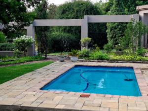 a swimming pool in a yard with a patio at Kaleb Guesthouse in Bethlehem