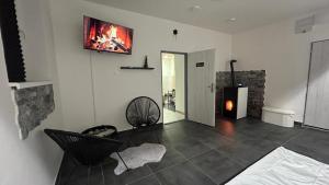 a living room with a fireplace and a couch at Hideaway in Ostrava