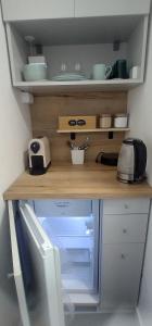 a wooden counter top with a microwave in a kitchen at Wittgruber's Upperroom in Koliba