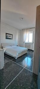 a bedroom with a large bed and a window at Via Roma 48 in Arquata Scrivia +12 photos