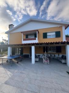 a house with a patio in front of it at Quinta Turki Malika in Óbidos