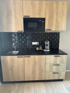 a kitchen with a sink and a microwave at Apartment central Lier in Lier +4 photos