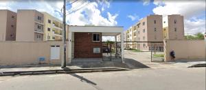 a man is standing in front of a building at Rogerio AP Compartilhado in Caucaia