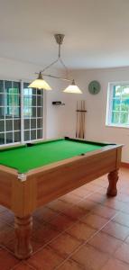 a living room with a pool table in a room at Quinta Turki Malika in Óbidos