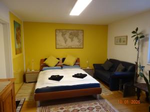a bedroom with a bed and a couch at Kleine Einliegerwohnung- komfort Home! in Lahnau