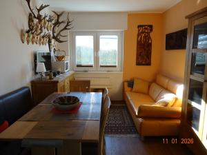 a living room with a couch and a table at Kleine Einliegerwohnung- komfort Home! in Lahnau