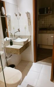 a bathroom with a sink and a toilet at STOP Mar Suite Privada - NI in Nova Iguaçu
