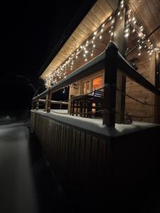 a cabin with lights on the deck at night at GRABNIK55 in Krasnobród +110 photos
