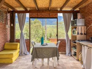 a table and chairs in a kitchen with a view at Chalé Agulhas Negras in Resende