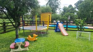 a childrens playground with a slide and a trampoline at Chácara Alci Guedes in São Gabriel