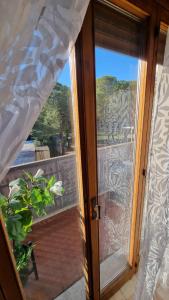 a sliding glass door with a view of a patio at Appartamento Orchidea in Monfalcone