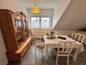 a dining room with a table and a cabinet at Vintage Traum in Hückelhoven