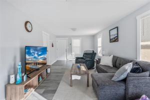 a living room with a couch and a tv at 404 W Maple Ave, Unit A in Wildwood