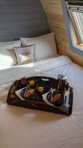 a tray of food sitting on a bed at Herons Rest Pod By The Sea in Morar Station