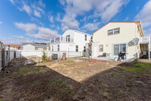 a white house with a fence in a yard at 404 W Maple Ave, Unit A in Wildwood