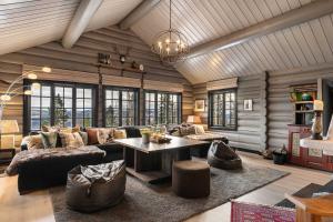 a living room with a couch and a table at TH590- Large ski-in out chalet with jacuzzi, sauna in Trysil in Trysil