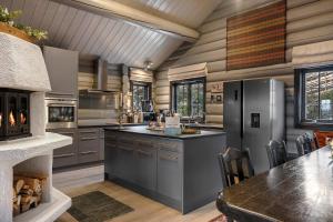 a kitchen with stainless steel appliances and a table at TH590- Large ski-in out chalet with jacuzzi, sauna in Trysil in Trysil