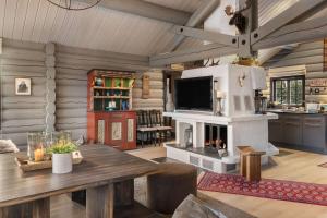 a living room with a table and a fireplace at TH590- Large ski-in out chalet with jacuzzi, sauna in Trysil in Trysil