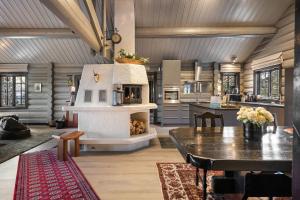 a kitchen with a fireplace and a table in a room at TH590- Large ski-in out chalet with jacuzzi, sauna in Trysil in Trysil +33 photos