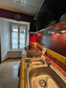 a kitchen with a sink and a stove at Gourmandise in Coutances
