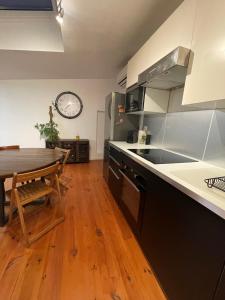 a kitchen with a wooden table and a wooden floor at L'Atelier Saint Michel in Bordeaux +1 photo