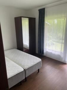 a bedroom with two beds and a large window at Коттедж in Lappeenranta