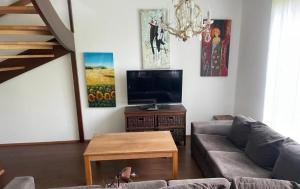 a living room with a couch and a flat screen tv at Коттедж in Lappeenranta +8 photos