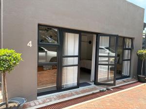 a room with sliding glass doors on a house at Canopy stay 4 in Sandton
