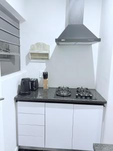 a kitchen with a stove top oven in a room at Canopy stay 4 in Sandton