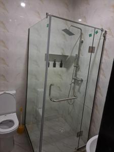a shower with a glass door in a bathroom at Diolux Serviced Apartments in Lekki