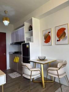 a kitchen with a table and chairs in a room at Ona's Condo in Bacolod