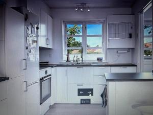 a white kitchen with a sink and a window at Grønningen Retreat in Billund