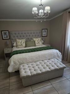 a bedroom with a large bed with a large tufted bed sidx sidx sidx at Kaleb Guesthouse in Bethlehem