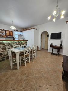 a kitchen and dining room with a table and chairs at Aspalathos I & ΙΙ in Kamárion