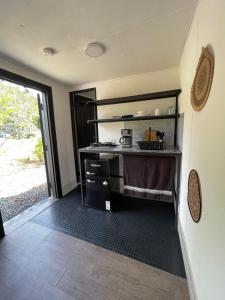 a kitchen with a stove and a counter top at CASA HARPIA Apartamentos Studio in Pedasí Town