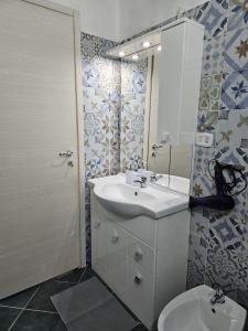a bathroom with a sink and a toilet at Casa Vacanze AFEA Torre dell'Orso Salento Puglia in Torre dell'Orso