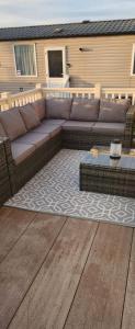 a brown couch sitting on top of a patio at Trecco Bay Private rentals in Newton