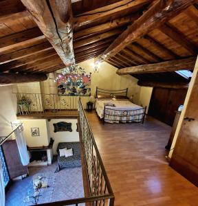a bedroom with a bed in a room with wooden ceilings at Antica Rupe 80 mq Casa Vacanze in Castel SantʼElia