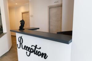 a reception desk with a black cat on top of it at La Corte Park Hotel & Spa in Palma Campania +52 photos