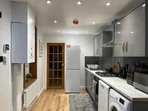 a kitchen with white appliances and a white refrigerator at Minstead Houses - 5 Bedroom Contractor House Sleeps 9 Parking for 2 Vans Near Bromford Duddeston Fort Dunlop Star City HS2 in Birmingham