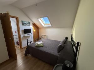 a bedroom with a bed and a skylight at Casa Manuel in Manteigas