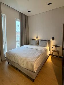 a bedroom with a large bed and a window at Mosh Mosh Boutique Hotel in Almaty