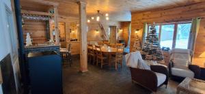 a kitchen and dining room with a christmas tree in a cabin at Les Grosses Pierres à Spa in Spa