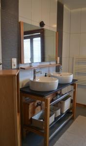a bathroom with two sinks and a mirror at Les Grosses Pierres à Spa in Spa +31 photos