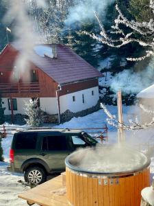 a large barrel of snow in front of a house at Cabana SVA Bilbor in Bilbor +2 photos
