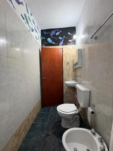 a bathroom with a toilet and a sink at Las tres lunas 2 in Villa Anizacate
