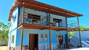 a blue house with a balcony on top of it at Paraíso Azul in Ilhéus