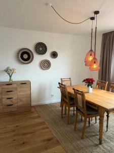 a dining room with a wooden table and chairs at Wanderlust East73 in Trier