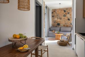 a kitchen and living room with a table and chairs at Norte Luxury Villas in Agioi Apostoli